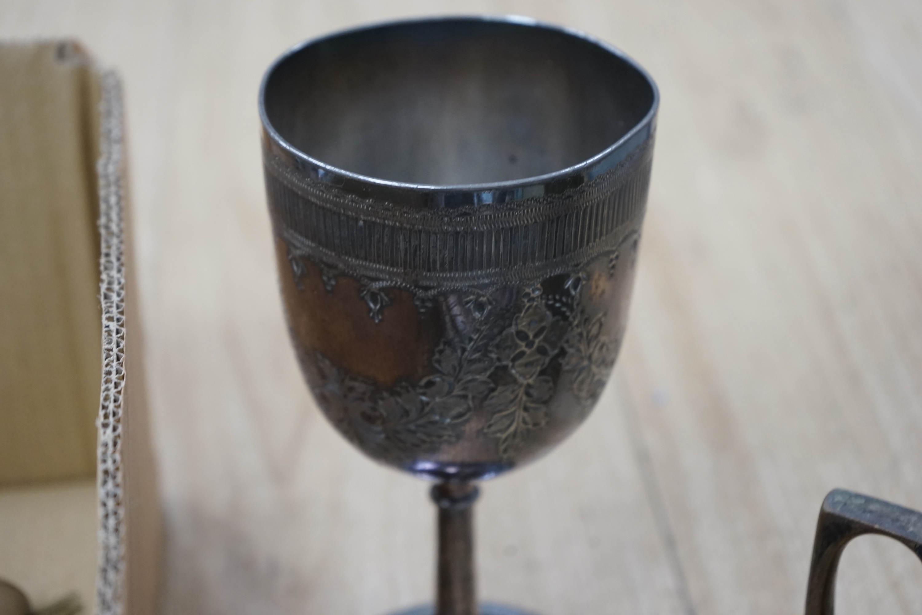 Assorted plated wares to include flatware, toast rack, biscuit barrel and goblet. Condition - fair